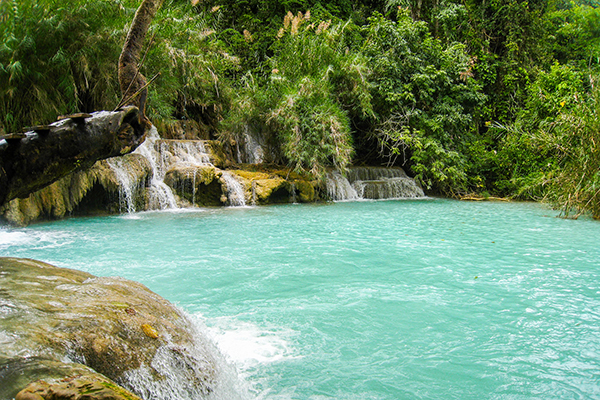 Deep blue water basins at Kuang Si Waterfall