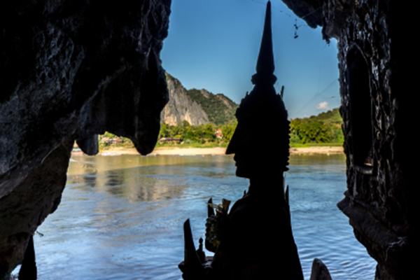 Inside Pak Ou cave, Buddha statues looking towards Nam Ou river