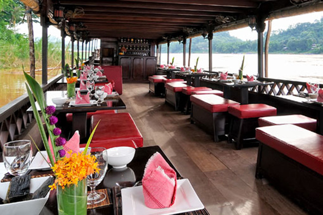 Sightseers enjoy a cruise dinner along the beautiful Mekong River