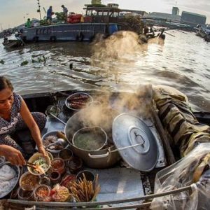 A Woman Sells Foods on Boat in Cai Rang Floating Market
