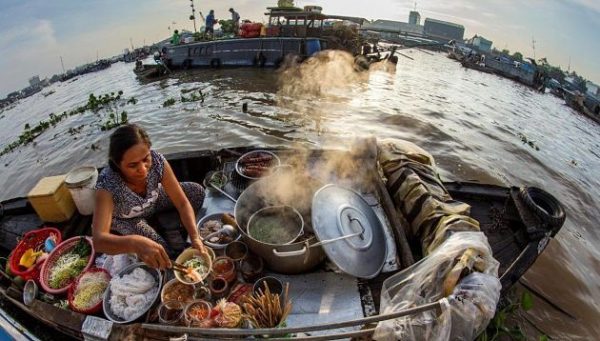 A Woman Sells Foods on Boat in Cai Rang Floating Market