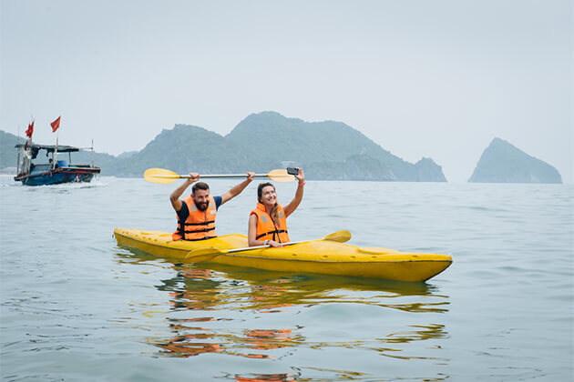 Couple Goes Kayaking on Halong Bay - Indochina Tour Packages