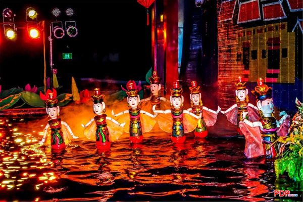 watching water puppet show in vietnam laos tour 11 days