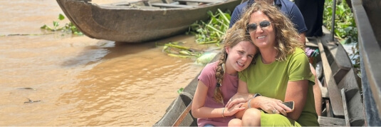Exploring the Mekong Delta by boat, a scenic river journey on Indochina tours